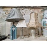 A Lladro porcelain table lamp and two others.