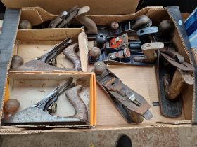 Eight woodworking hand planes.