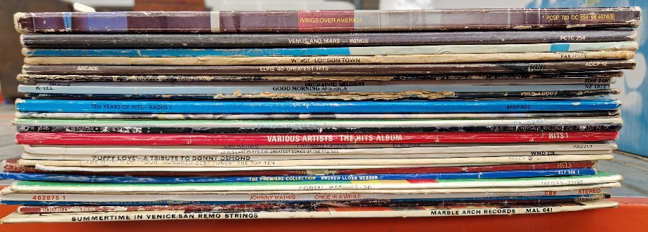 A box of vinyl LP records, rock and pop including Wings, Bowie, etc.