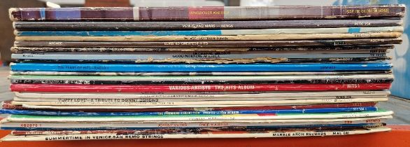 A box of vinyl LP records, rock and pop including Wings, Bowie, etc.