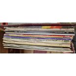 A box of vinyl LP records, rock and pop including ELO, Phil Collins, Bruce Springsteen, Jean