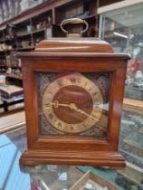 A reproduction mahogany bracket clock