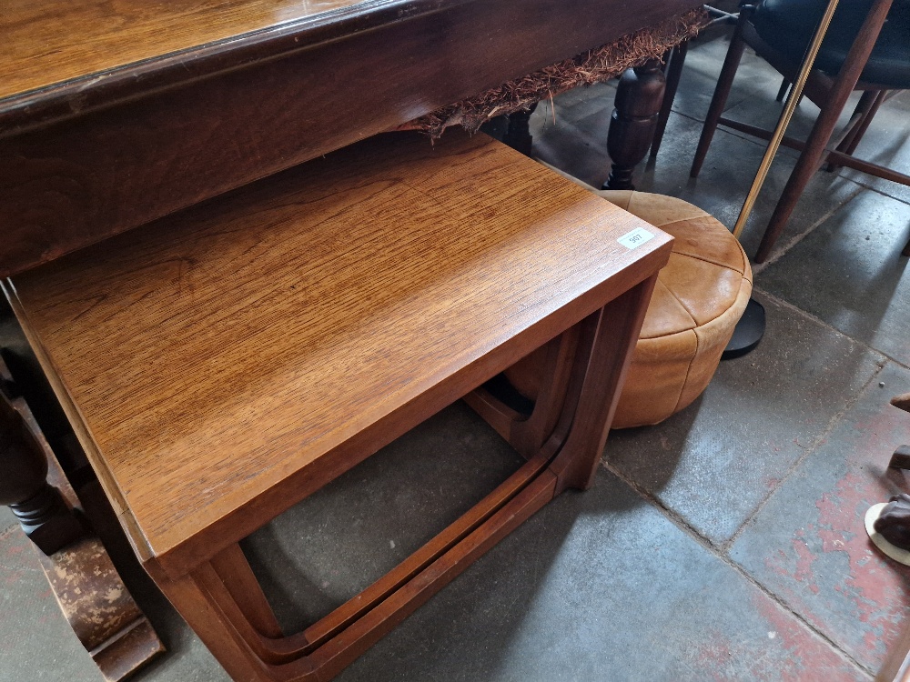 A mixed lot comprising mid 20th century teak nest of tables, retro leather pouffe and a floor