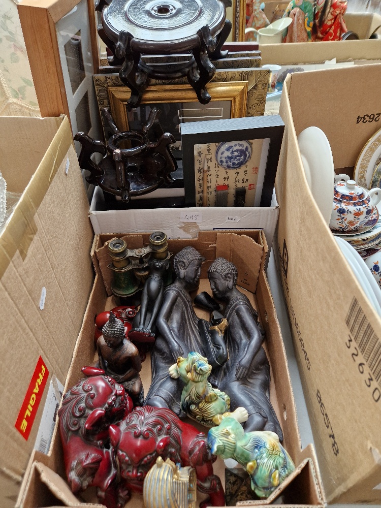 A box of assorted modern oriental and Egyptian ornaments and a box of similar pictures, also
