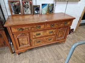 An Edwardian walnut sideboard with Art Nouveau style brass handles.