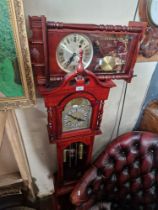 A reproduction granddaughter clock and a reproduction wall clock.