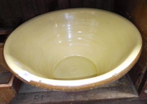 A large lined terra cotta proving bowl