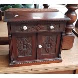 A Victorian carved oak miniature chiffonier/sideboard with ceramic handles.