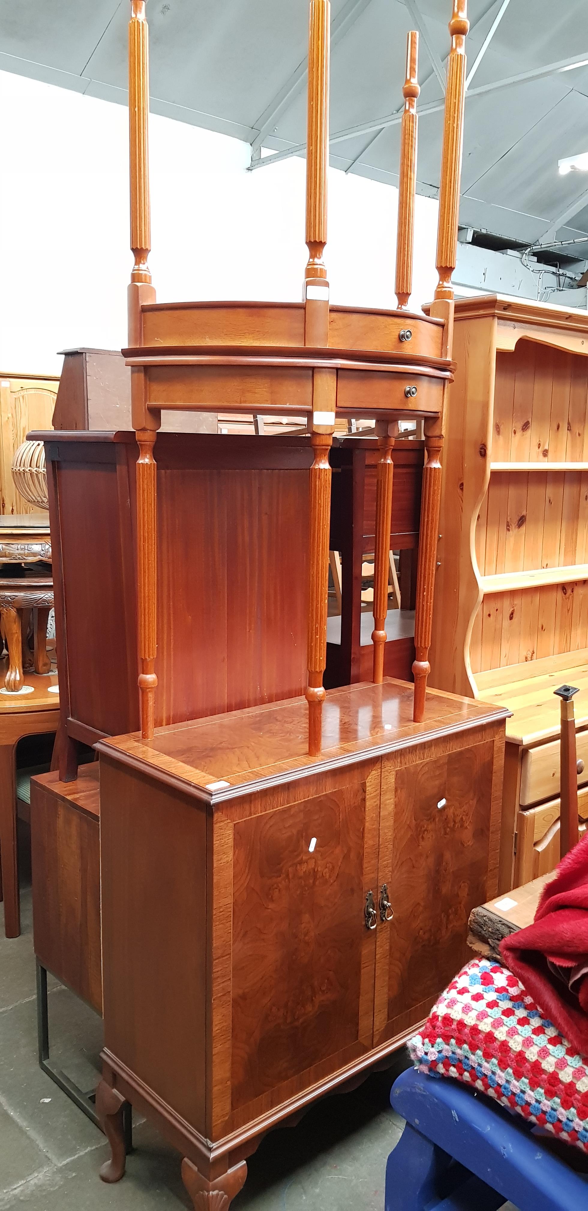 A walnut drinks cabinet together with a pair of demi-lune side tables.