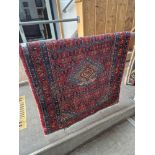A Middle Eastern hand knotted wool runner, red ground 84cm x 287cm.