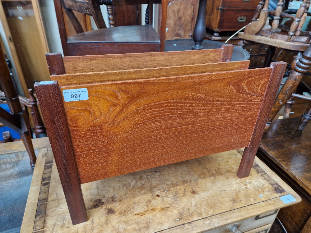 A mid 20th century teak magazine rack.