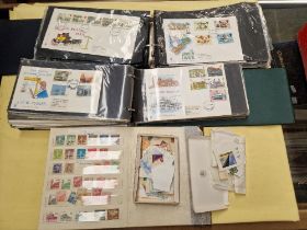 A box containing First Day Covers, stamp album and loose stamps