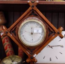 An antique oak cased barometer and thermometer