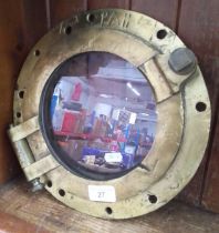 A brass port hole window.