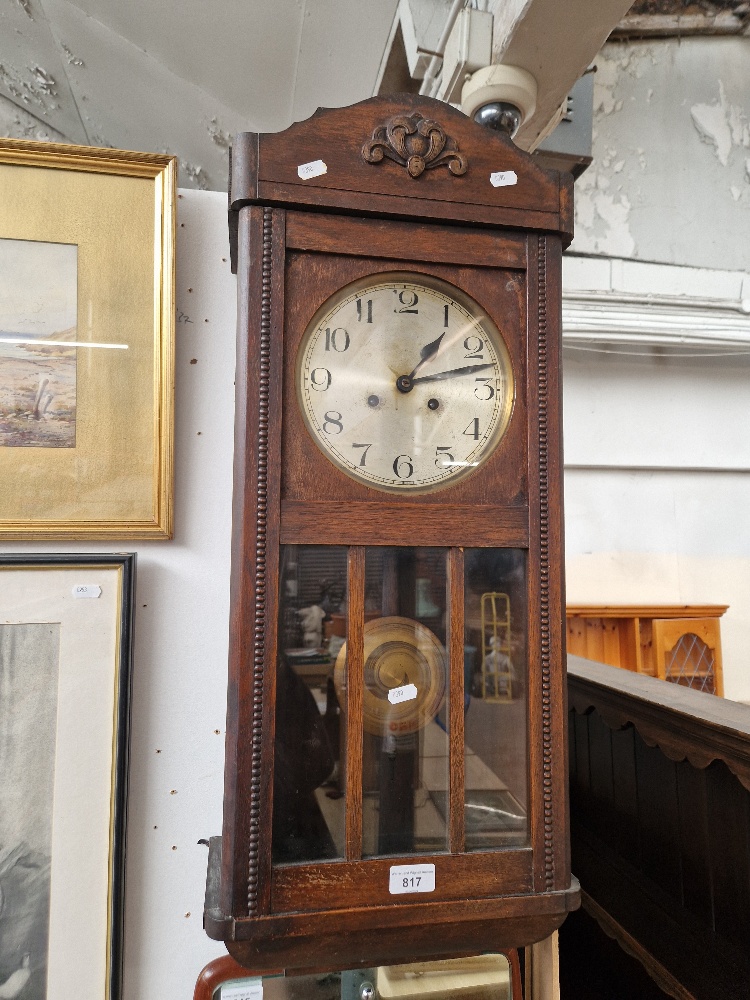 An early 20th century oak cased wall clock.