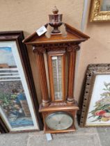 An oak framed barometer/thermometer.