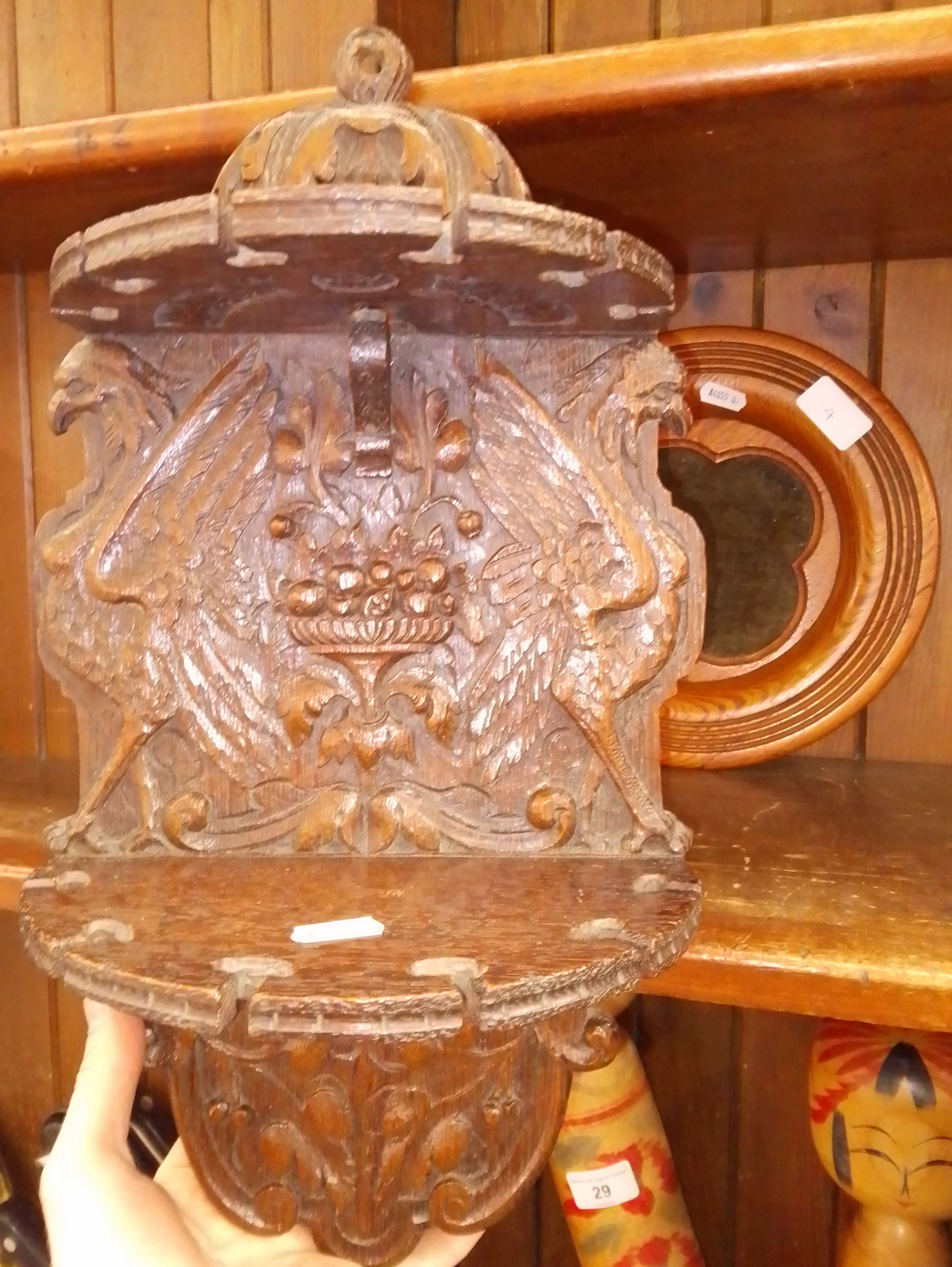 A carved two tier wall mounted pipe rack and a church collection tray.