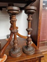 A pair of early 20th century carved oak candle sticks.