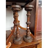 A pair of early 20th century carved oak candle sticks.