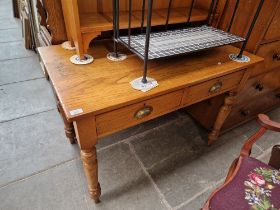 An Edwardian golden oak two drawer side table.