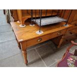 An Edwardian golden oak two drawer side table.