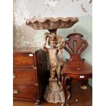 An Italian carved wood putti with half clam shell above his head, height 101cm.