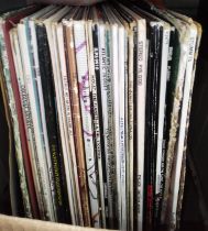 A box of vinyl LP records, rock and pop including Queen, The Police, Madonna, Erasure, Adam Ant,