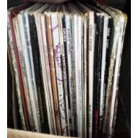 A box of vinyl LP records, rock and pop including Queen, The Police, Madonna, Erasure, Adam Ant,