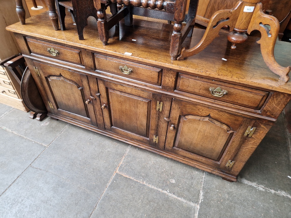 An aged oak sideboard, length 169cm.