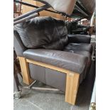An oak and brown leather two seater sofa.