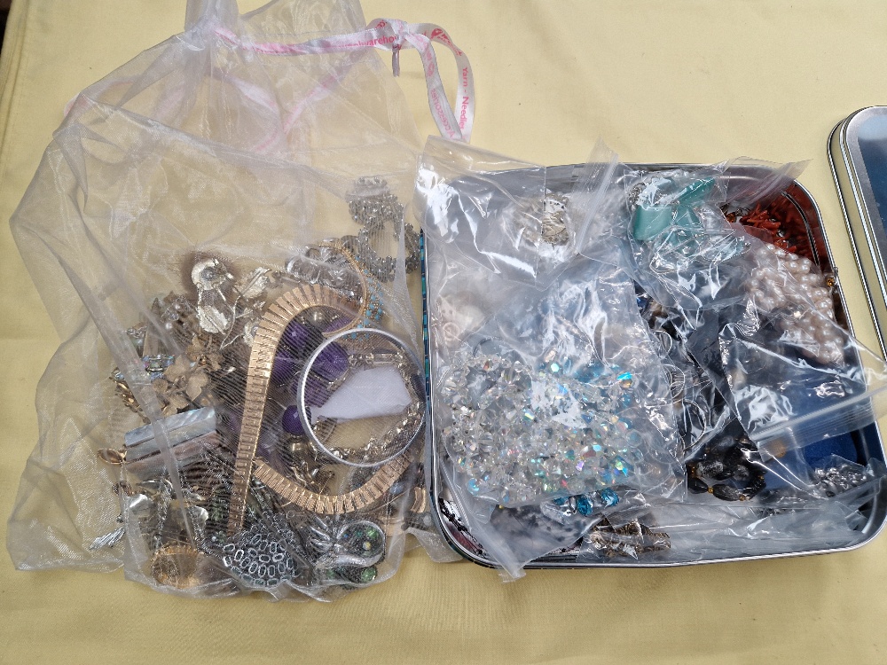 Tin of costume jewellery