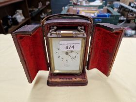 A brass carriage clock, the dial signed 'John Elkan', with leather case and key.