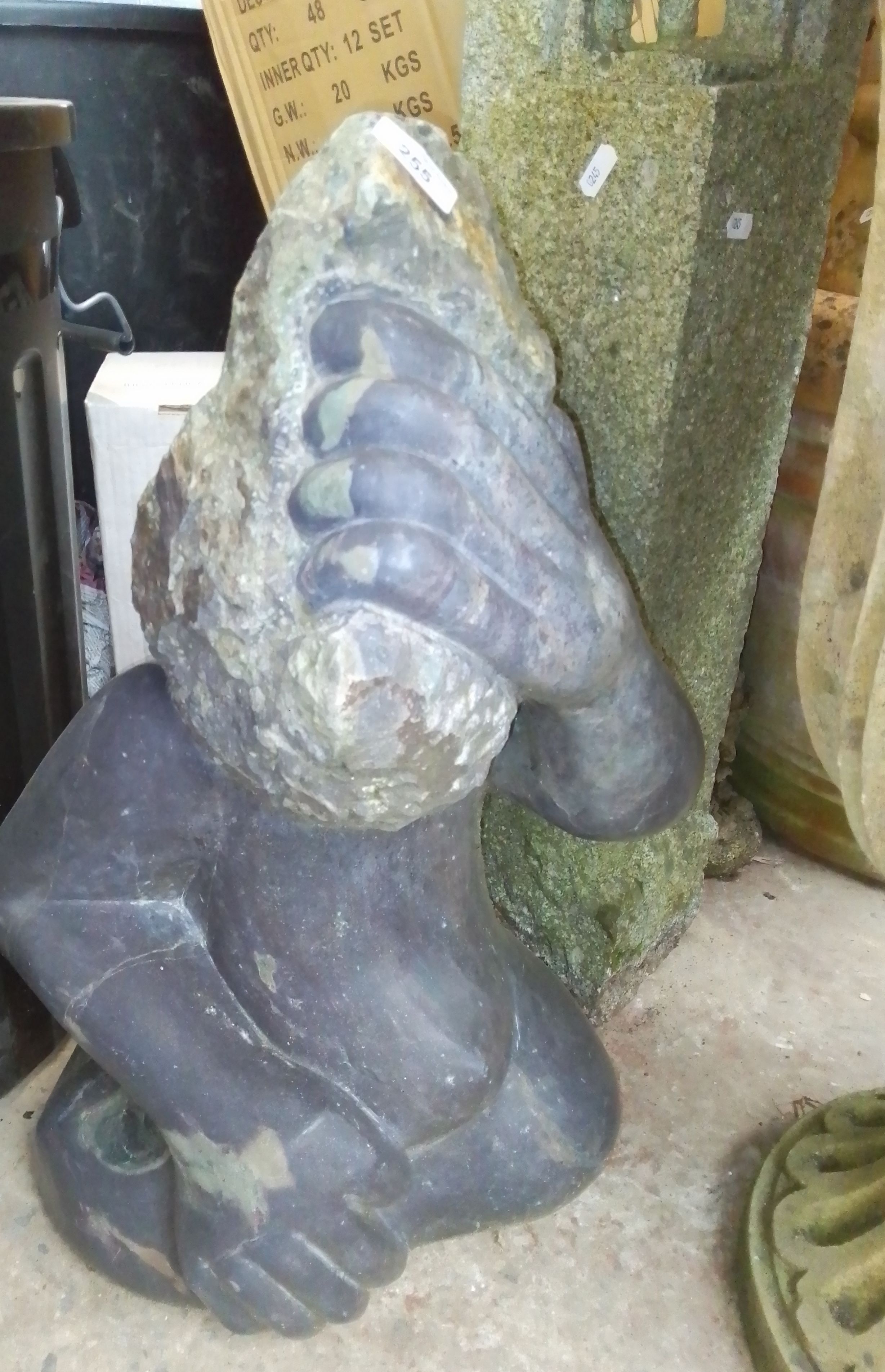 A polished stone garden ornament formed as a monkey, a concrete column, a mushroom, tortoise,