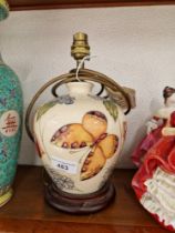 A Moorcroft pottery table lamp decorated with butterflies.