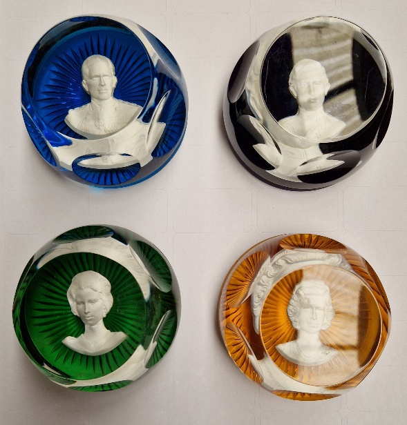 A group of four assorted Baccarat glass paperweights with encased Royal portraits.