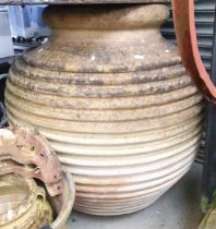 A very large terracotta olive storage jar