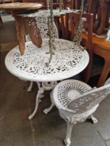 A cast metal garden table and two chairs.