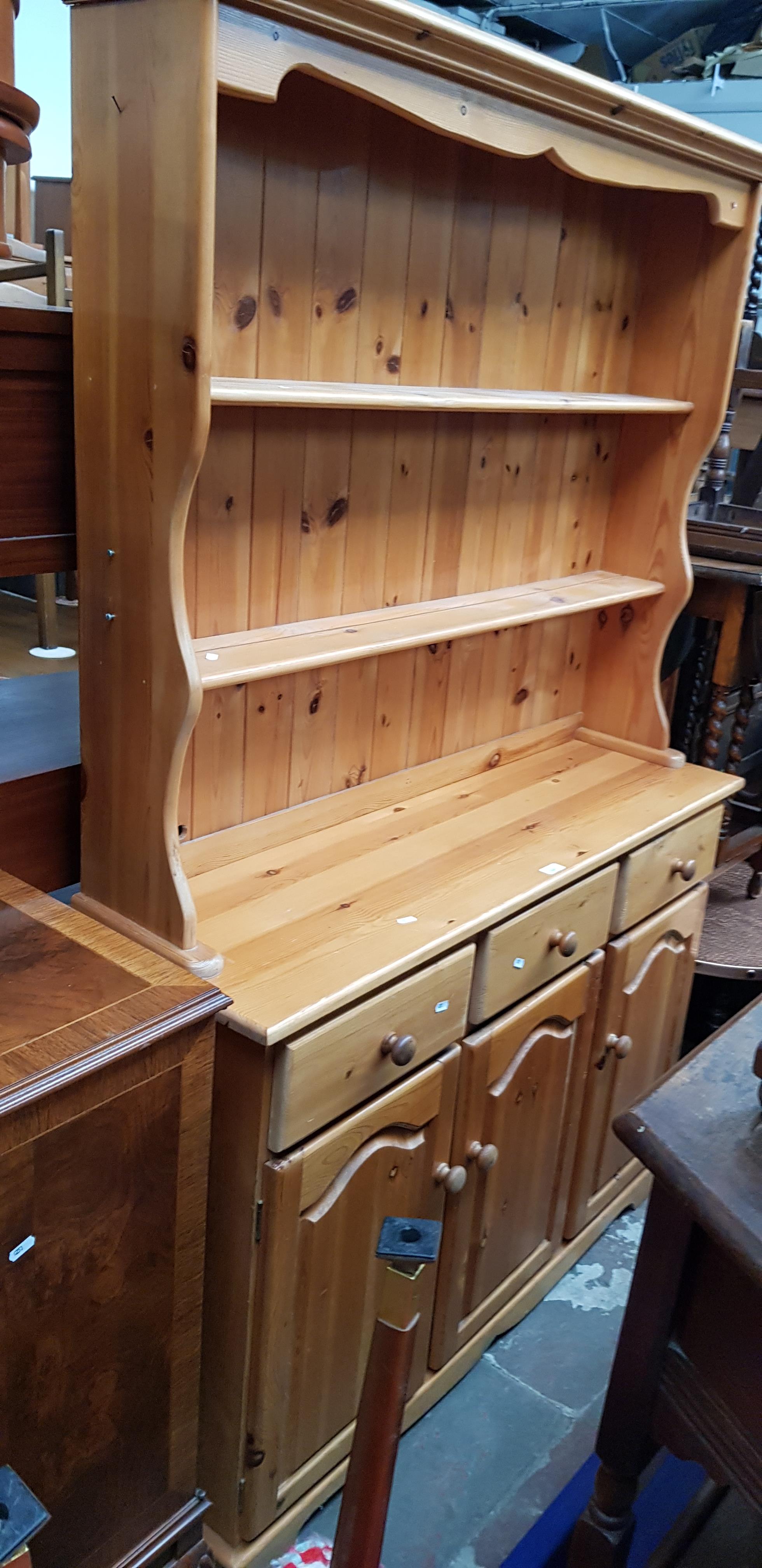 A pine dresser with plate rack back.