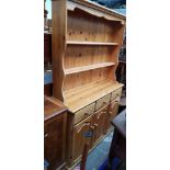 A pine dresser with plate rack back.