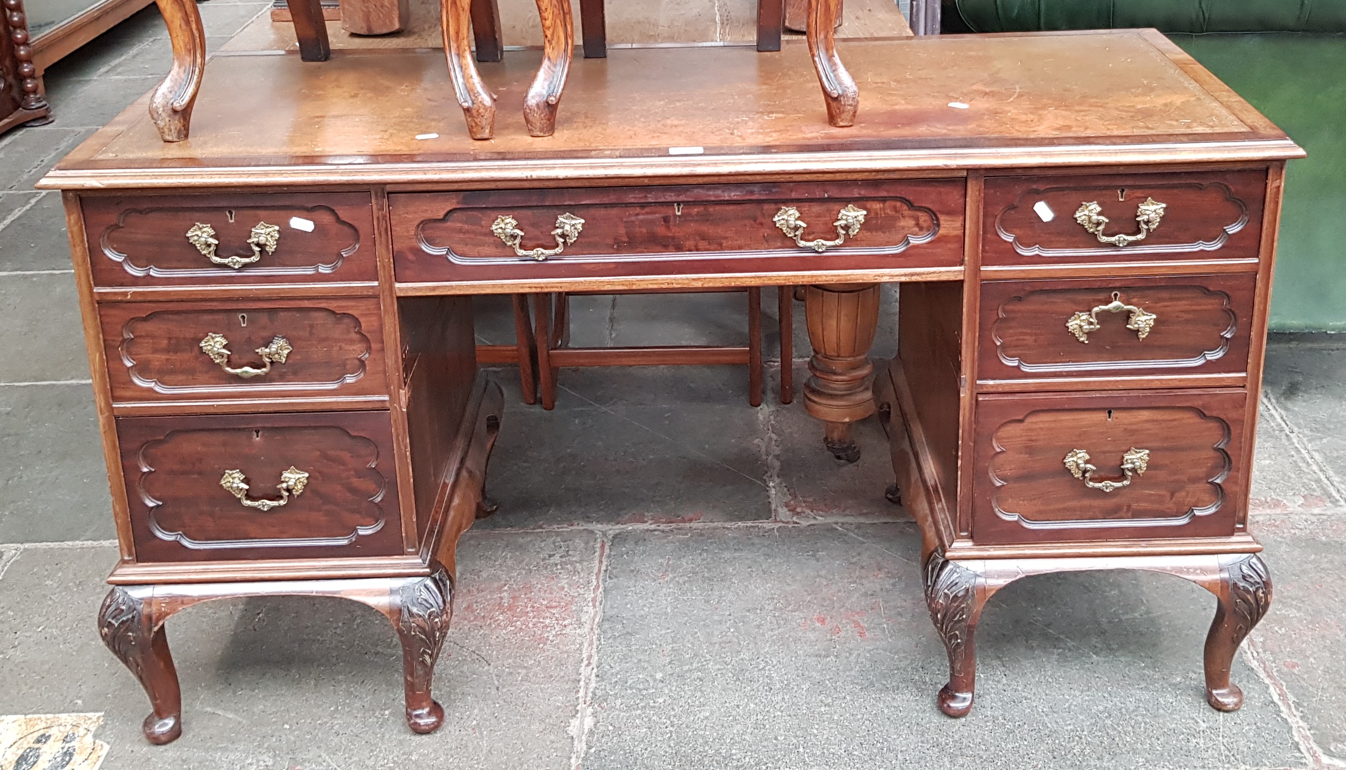 An Edwardian mahogany desk with tooled leather writing surface, the locks marked 'RC&S' with a