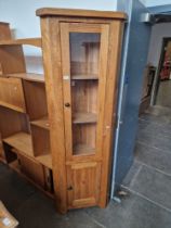 A modern oak corner cabinet.