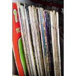 A box of vinyl LP records, rock and pop including Simon & Garfunkel, Bob Dylan, etc.