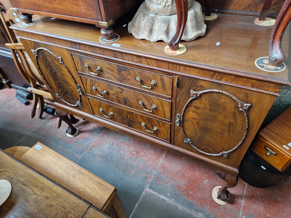 An early 20th century mahogany sideboard on ball and claw feet.