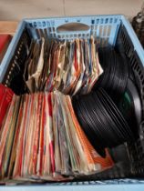 A box of 7" vinyl singles including Elvis, etc.