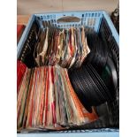 A box of 7" vinyl singles including Elvis, etc.