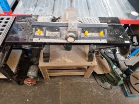 A Wolfcraft craft table with Bosch router and a bench grinder.