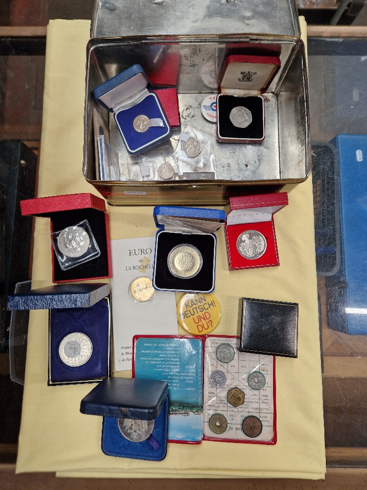 A tin of assorted commemorative coins