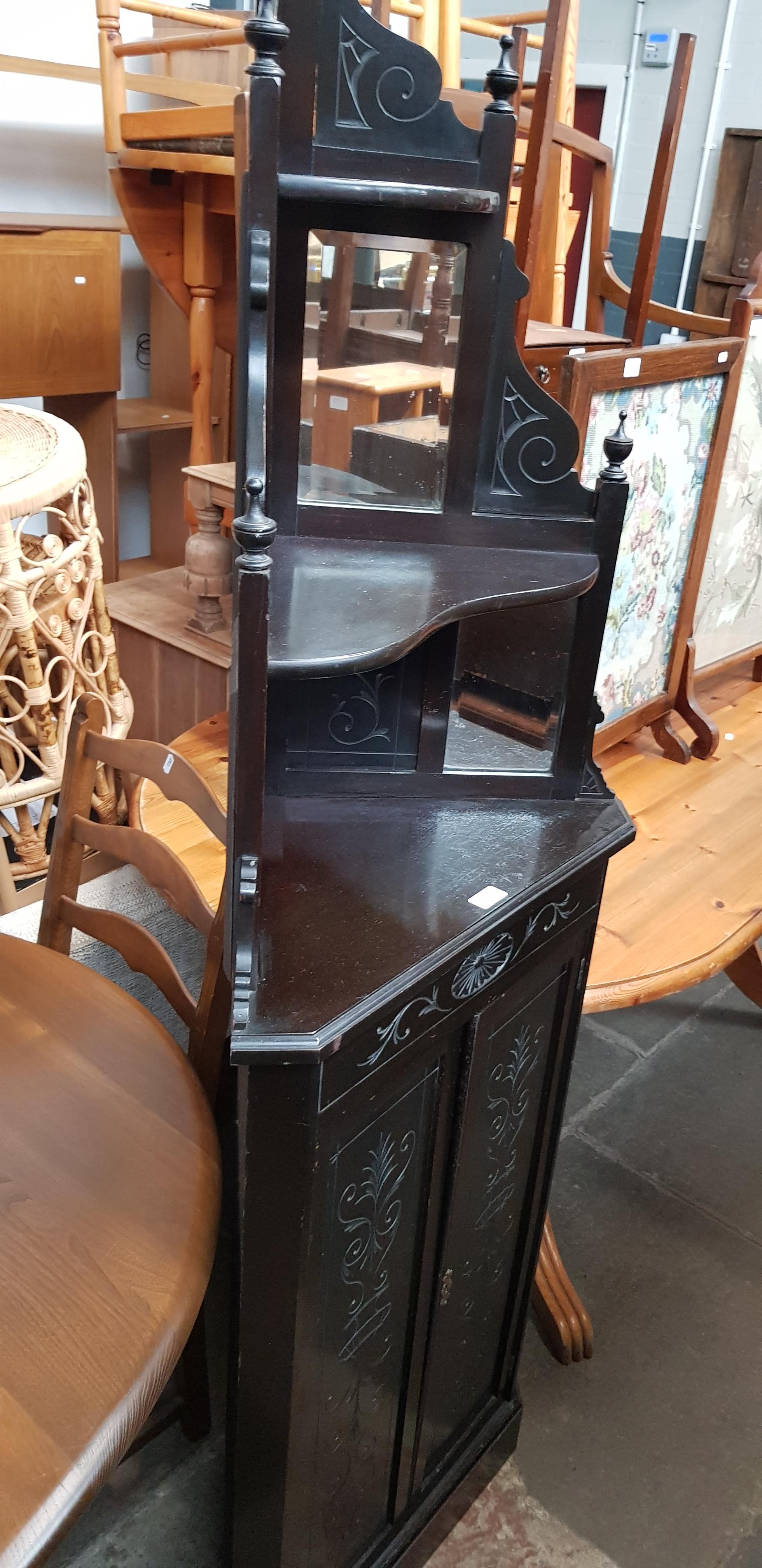 A late Victorian Aesthetic Movement ebonised corner cabinet.