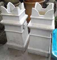 A pair of chimney pot crowns