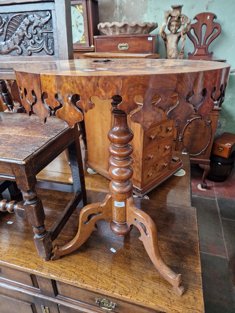A Victorian oak and walnut parquetry inlaid pedestal table with various specimen woods to the top.